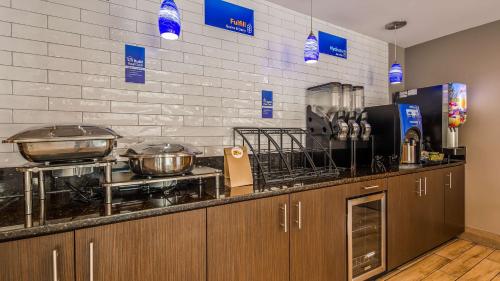 a kitchen with pots and pans on a counter at Best Western Inn Florence in Florence