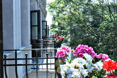 a bunch of pink and white flowers on a balcony at Hotel Troya Balat in Istanbul