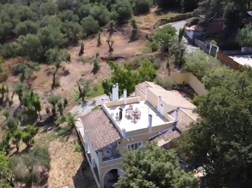 an aerial view of a large house with trees at Olea Home in Agia Pelagia Chlomou