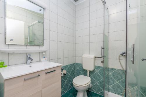 a bathroom with a toilet and a sink and a shower at Bellona in Malinska