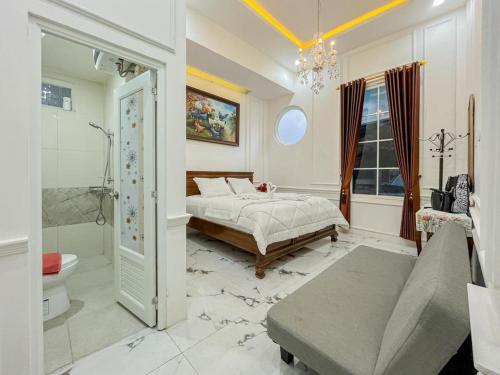 a bedroom with a bed and a bath room at Sakura Guest House by The Lavana in Batu