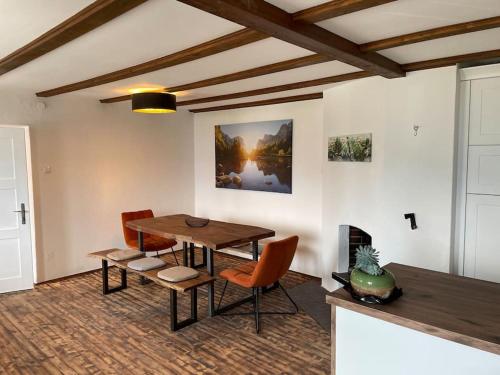 a dining room with a wooden table and chairs at Villa Sonnenwinkl - Reith bei Seefeld in Reith bei Seefeld