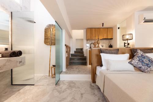 a living room with a couch and a staircase at Athina Studios and Suites Plaka in Plaka