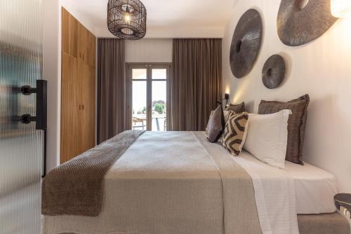 a bedroom with a large bed with pillows at Athina Studios and Suites Plaka in Plaka