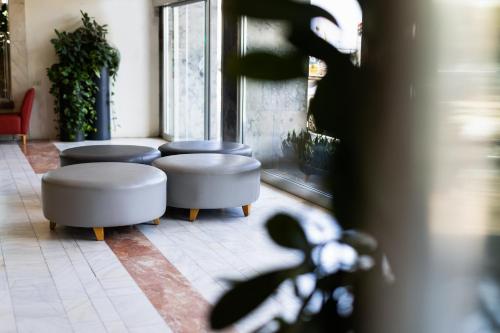 a row of stools in a room with windows at Grand Beach Hotel in Tel Aviv