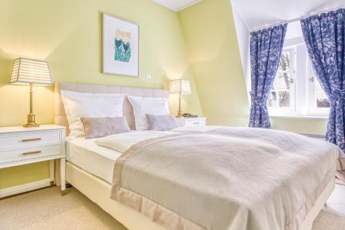 a bedroom with a large bed with blue curtains at Wald & Schlosshotel Friedrichsruhe in Friedrichsruhe