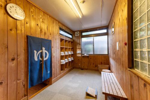 a room with a flag on the wall and a clock at 檜湯の宿　松伯 in Aoki-gemi