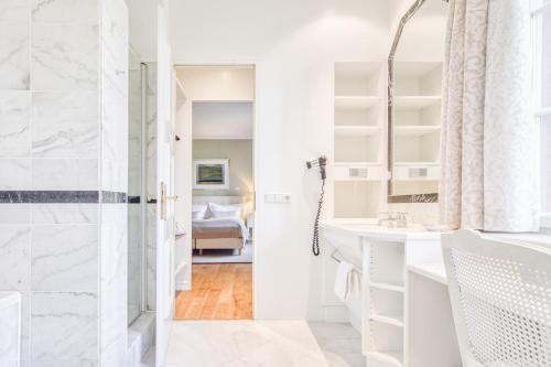 a white bathroom with a shower and a sink at Wald & Schlosshotel Friedrichsruhe in Friedrichsruhe