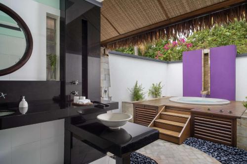 a bathroom with a sink and a bath tub at Dhawa Ihuru in Male City