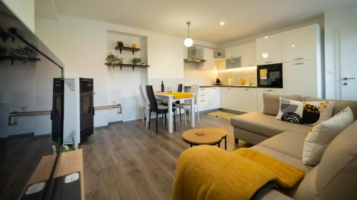 a living room and kitchen with a couch and a table at Gogo in Delnice