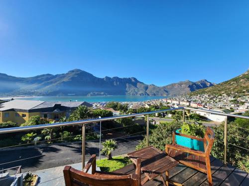 a balcony with two chairs and a view of a city at Hout Bay Breeze in Hout Bay