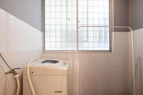 a washing machine in a bathroom with a window at Kids Dream Home with Slides 4Bedroom2Bath 14pax LRT in Kuala Lumpur