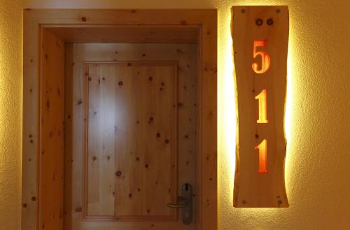 a door with a number on the side of a wall at Hotel Alpenfrieden in Rio Bianco