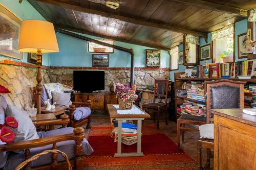 a living room filled with furniture and a tv at La pieve - Mimose in Pereta