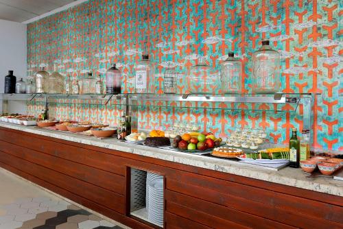 a buffet line with plates of food and drinks at Grand Palladium Select Palace Ibiza - All Inclusive in Playa d'en Bossa