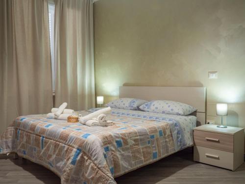a bedroom with a bed with two stuffed animals on it at Villa Paestum in Paestum