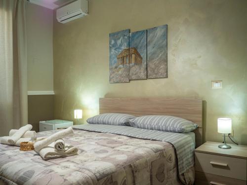 a bedroom with a bed with towels on it at Villa Paestum in Paestum
