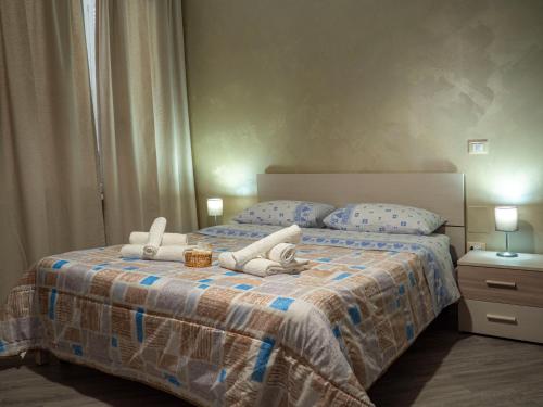 a bedroom with a bed with two stuffed animals on it at Villa Paestum in Paestum