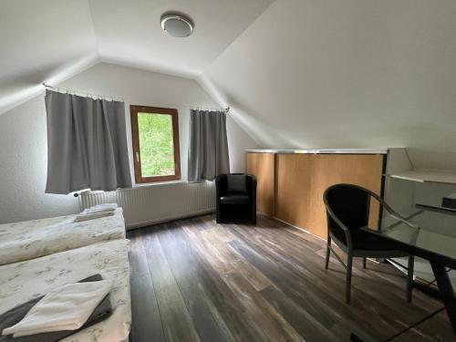 a room with a bed and a desk and a window at Haus mit 4 Schlafmöglichkeiten in Hamburg