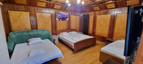 a small room with two beds and a couch at Ривер Гагра in Gagra