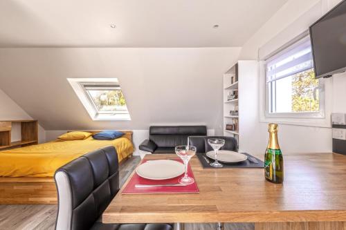 a room with a bed and a dining room with a table at Le Sémaphore de Trézien in Plouarzel