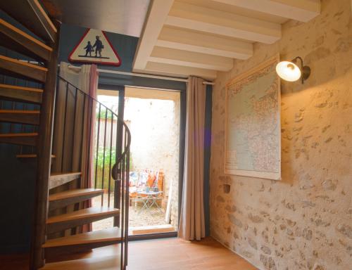 a room with a staircase and a door with a window at La Belle lurette in Bressuire