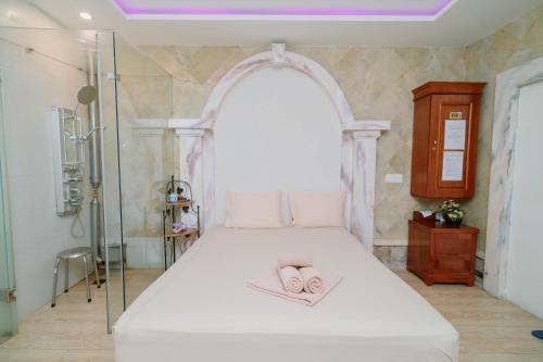 a bedroom with a bed with two slippers on it at A25 Luxury Hotel in Hanoi