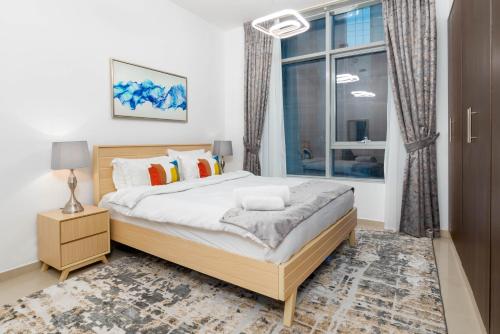 a bedroom with a large bed and a window at SuperHost - Sophisticated and Homey apartment Near to Metro in Dubai