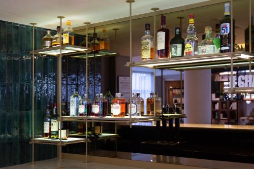 a bar with lots of bottles of alcohol on shelves at Paxton Paris MLV in Ferrières-en-Brie