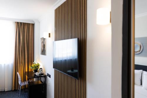 a hotel room with a large mirror on the wall at Grand Beach Hotel in Tel Aviv
