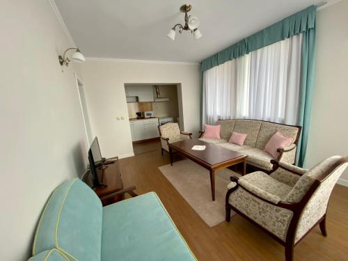 a living room with a couch and a table at Wild Cherry Apartments in Saints Constantine and Helena