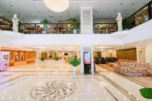 a lobby of a hotel with couches and chairs at A25 Luxury Hotel in Hanoi