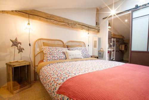a bedroom with a large bed with a red blanket at La Belle lurette in Bressuire