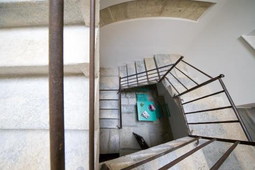 a spiral staircase in a building with a wall at B&B Cantiere dell'anima - Rooms of art in Trapani