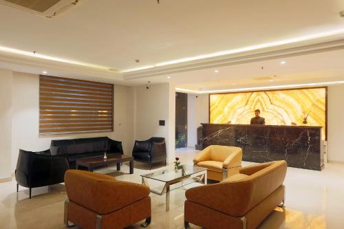 a living room with a couch and chairs and a table at HOTEL LE SEASONS PARK in Greater Noida