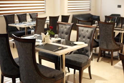 a dining room with a table and chairs at HOTEL LE SEASONS PARK in Greater Noida