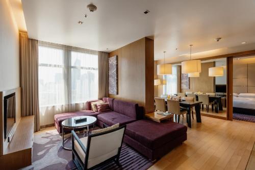 a living room with a couch and a dining room at Marriott Executive Apartments Bangkok, Sukhumvit Thonglor in Bangkok