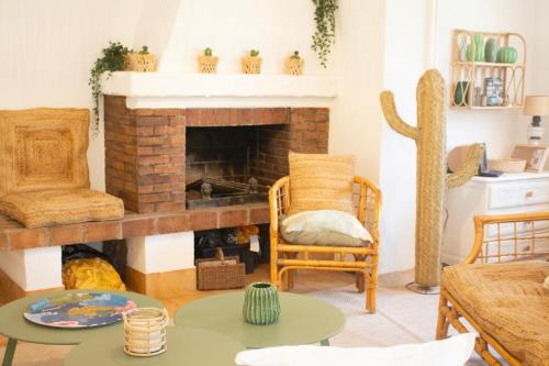 a living room with a fireplace and a chair at Same Home in Cassis