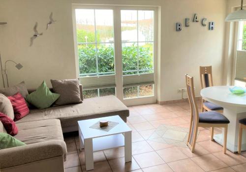 a living room with a couch and a table at Strandtraum in Glowe