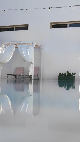 a white room with a tent and a table at La Gemma del Salento Rooms&Apartments in Racale