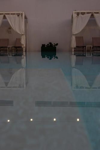 an empty room with a table and some chairs at La Gemma del Salento Rooms&Apartments in Racale