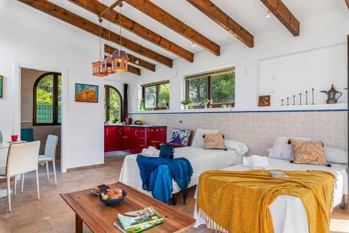 una sala de estar con dos camas y una mesa en Villa Rosa 5 - PlusHolidays, en Altea