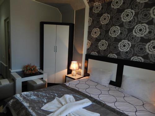 a bedroom with a large bed and a mirror at B&B Europa Hotel in Kutaisi