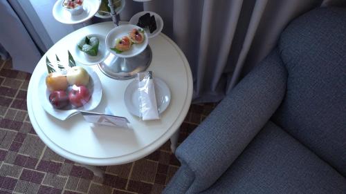 a white table with plates of food on it at Aryaduta Makassar in Makassar