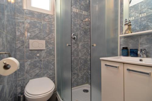 a bathroom with a shower and a toilet and a sink at Apartment Senada 1503 in Galižana