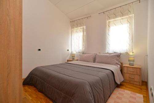a bedroom with a large bed and a window at Apartment Senada 1503 in Galižana