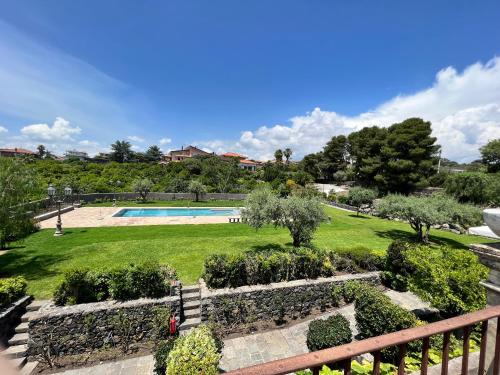 a view of a garden with a swimming pool at Casa la Carrubbazza in San Gregorio di Catania