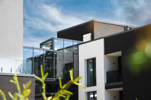 a black and white building with glass windows at Rest&Ski Spa Resort in Bukovel