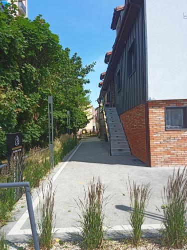 a building with stairs to the side of it at Apartamenty Na Skarpie in Płock
