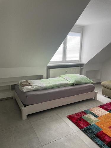 a bedroom with a bed with a window and a rug at Joanna Apartment - MA City 2 in Mannheim